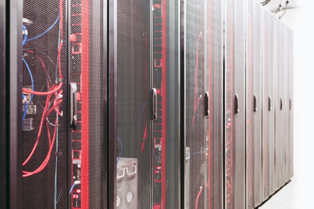 Modern data server room with network racks and cables.